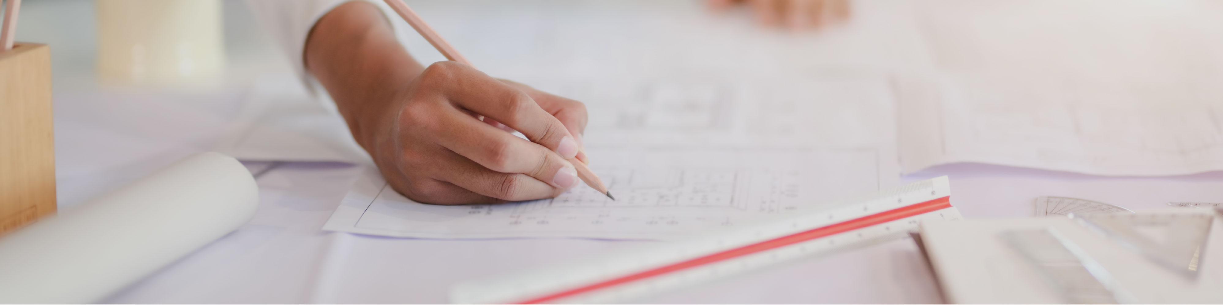 image of a person reviewing blue prints